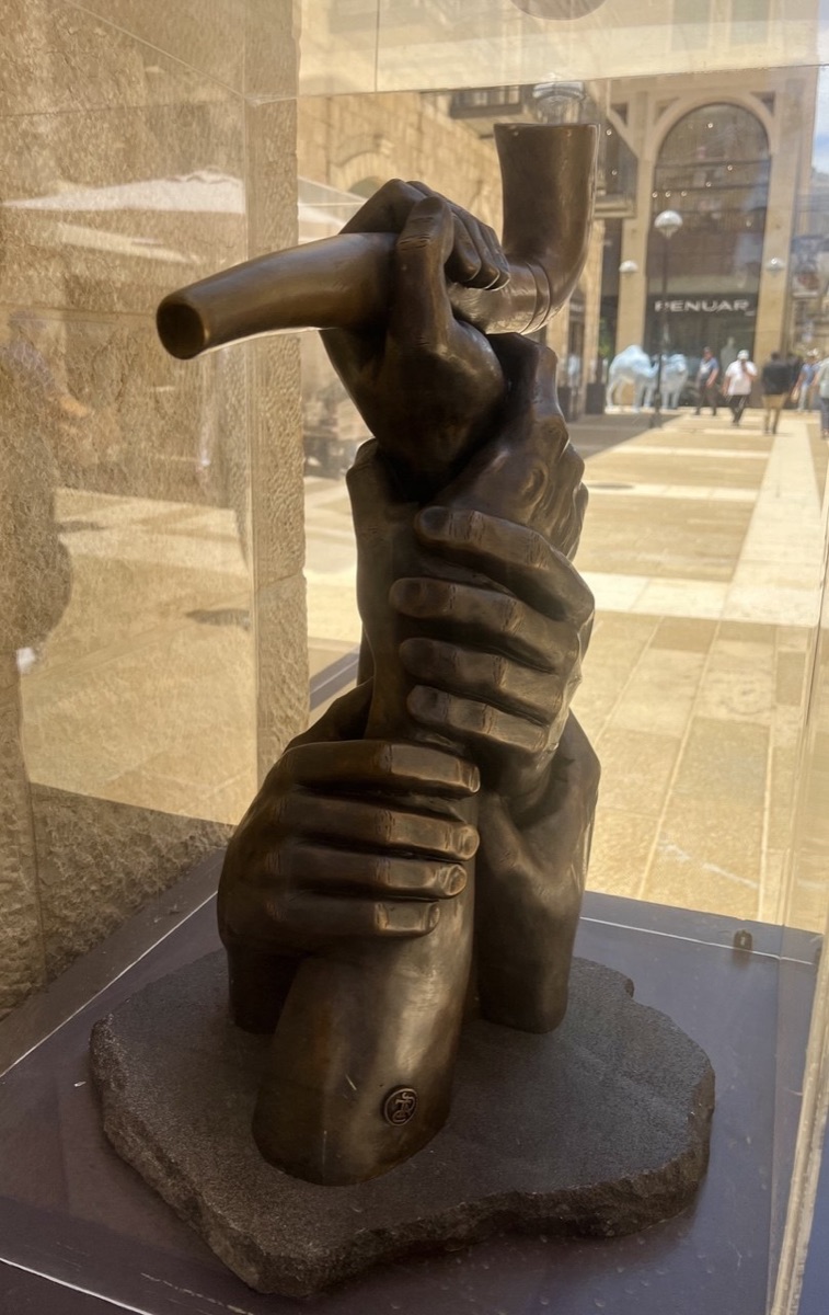 The Great Shofar bronze sculpture installed in a glass case at Mamilla Mall, Jerusalem
